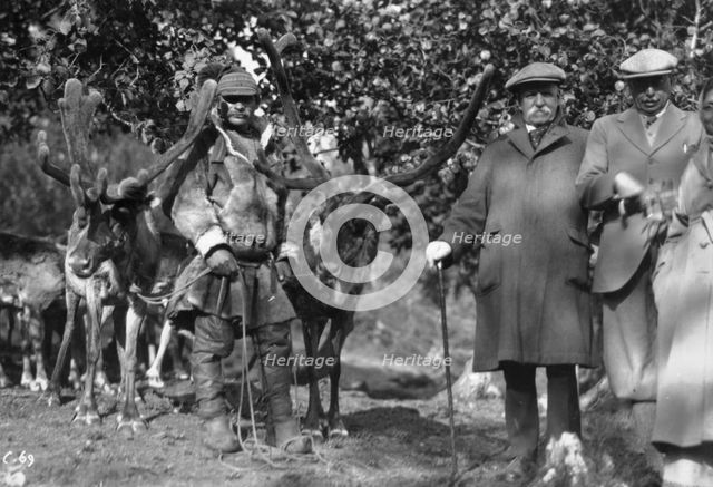 Tourists posing alongside a man with reindeer, Lyngen, Norway, 1929. Artist: Unknown