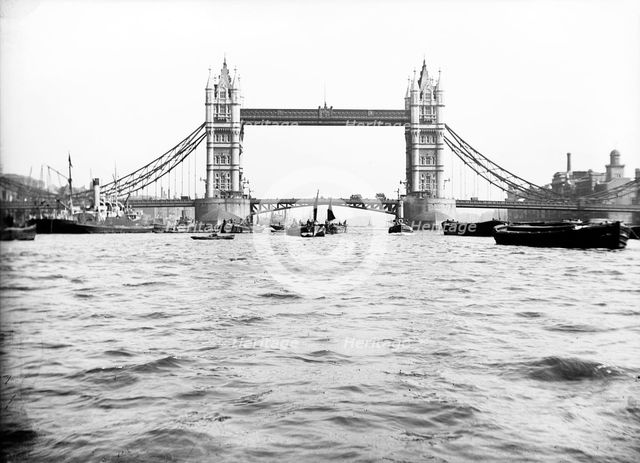 Tower Bridge with bascules closed and barges passing under at high water, London, c1905. Artist: Unknown