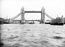 Tower Bridge with bascules closed and barges passing under at high water, London, c1905
