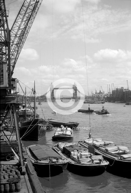Tower Bridge with shipping in the Pool of London and vessels at Hay's Wharf, Southwark, c1945-c1965. Artist: SW Rawlings