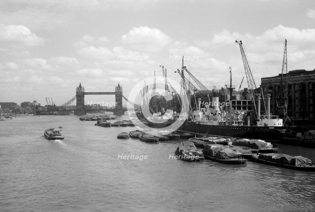 Tower Bridge with shipping in the Pool of London and at Hay's Wharf, Southwark, London, c1945-c1965. Artist: SW Rawlings