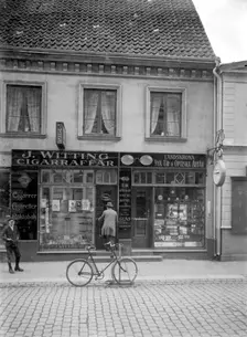 Tobacconist's and horologist's shops, Landskrona, Sweden, 1920. Creator: Unknown