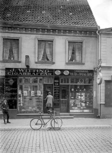 Tobacconist's and horologist's shops, Landskrona, Sweden, 1920. Creator: Unknown