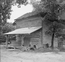 Tobacco barn with tobacco sled and vehicle..., Person County, North Carolina, 1939. Creator: Dorothea Lange