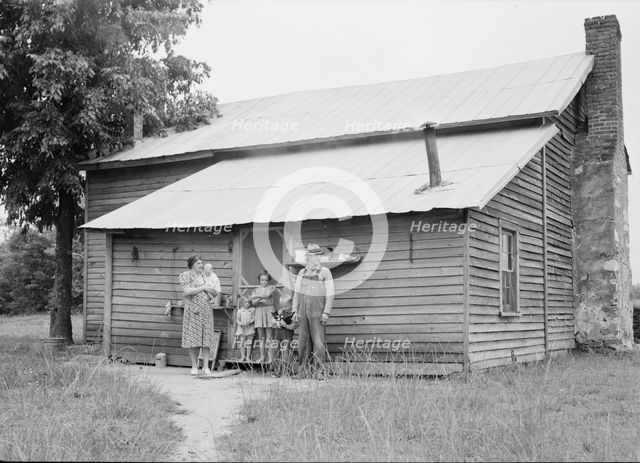 Tobacco sharecropper and his family at the back..., Person County, North Carolina, 1939. Creator: Dorothea Lange.
