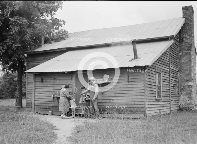 Tobacco sharecropper and his family at the back..., Person County, North Carolina, 1939. Creator: Dorothea Lange.