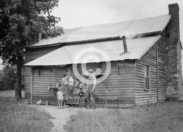 Tobacco sharecropper and his family at the back..., Person County, North Carolina, 1939. Creator: Dorothea Lange.