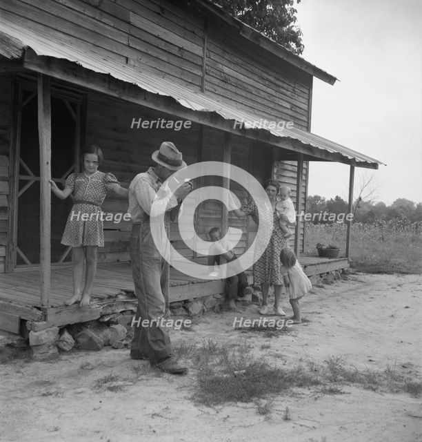 Tobacco sharecropper ready to return to the field, Person County, North Carolina, 1939. Creator: Dorothea Lange.