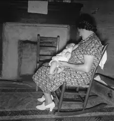 Tobacco sharecropper's wife nurses the baby after washing..., Person County, North Carolina, 1939. Creator: Dorothea Lange
