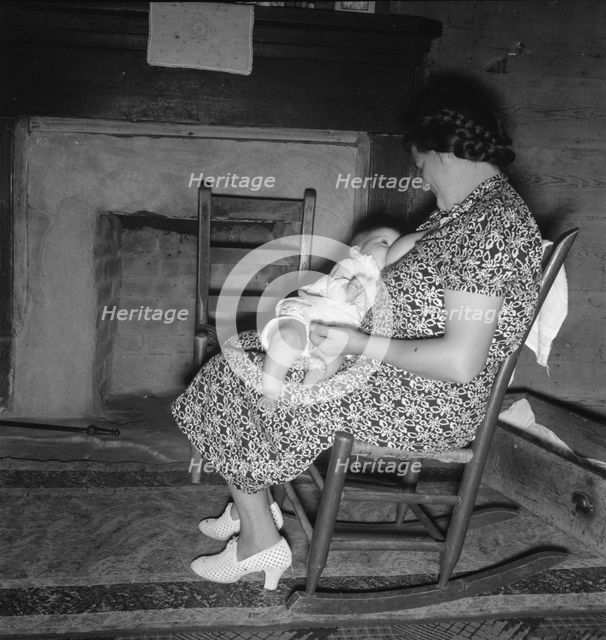 Tobacco sharecropper's wife nurses the baby after washing..., Person County, North Carolina, 1939. Creator: Dorothea Lange.