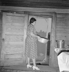 Tobacco sharecropper's wife disposing of dishwater..., Person County, North Carolina, 1939. Creator: Dorothea Lange
