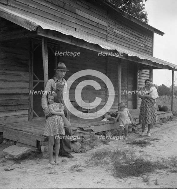 Tobacco sharecropper with his oldest daughter, Person County, North Carolina, 1939. Creator: Dorothea Lange.