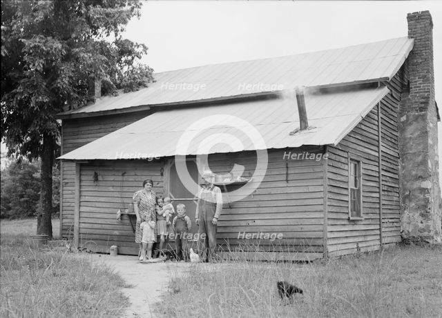 Tobacco sharecroppers and family at back of their house, Person County, North Carolina, 1939. Creator: Dorothea Lange.