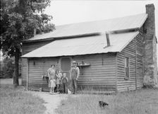 Tobacco sharecroppers and family at back of their house, Person County, North Carolina, 1939. Creator: Dorothea Lange