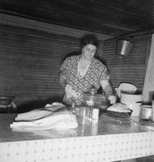 Tobacco sharecropper's wife cleaning up table after washing..., Person County, North Carolina, 1939. Creator: Dorothea Lange