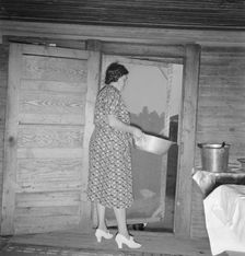 Tobacco sharecropper's wife disposing of dishwater..., Person County, North Carolina, 1939. Creator: Dorothea Lange