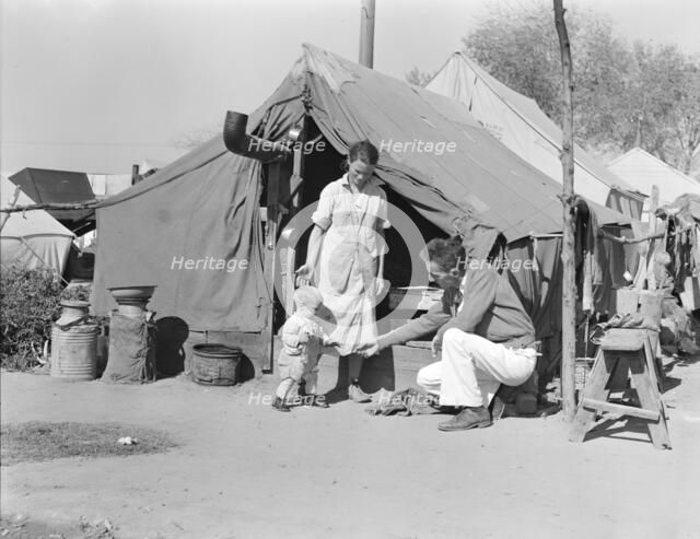 Tom Collins, manager of Kern migrant camp, with drought refugee family, California, 1936. Creator: Dorothea Lange.