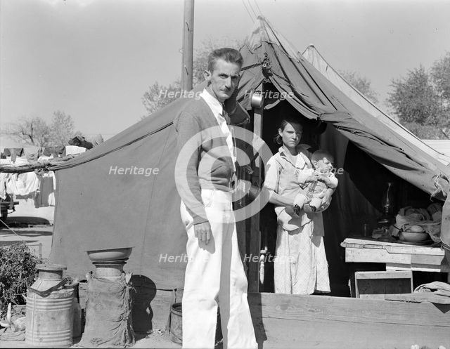 Tom Collins, manager of Kern migrant camp, California, with migrant mother and child, 1936. Creator: Dorothea Lange.