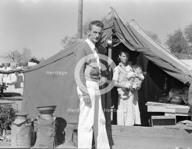 Tom Collins, manager of Kern migrant camp, California, with migrant mother and child, 1936. Creator: Dorothea Lange.