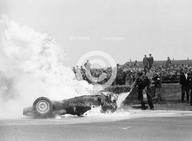 Tony Brooks' car on fire at the British Grand Prix, Silverstone, Northamptonshire,1956. Artist: Unknown