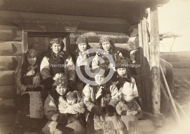 Tatar women with children seated in front of their home, between 1885 and 1886. Creator: Unknown.