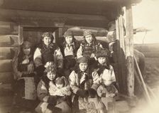 Tatar women with children seated in front of their home, between 1885 and 1886. Creator: Unknown
