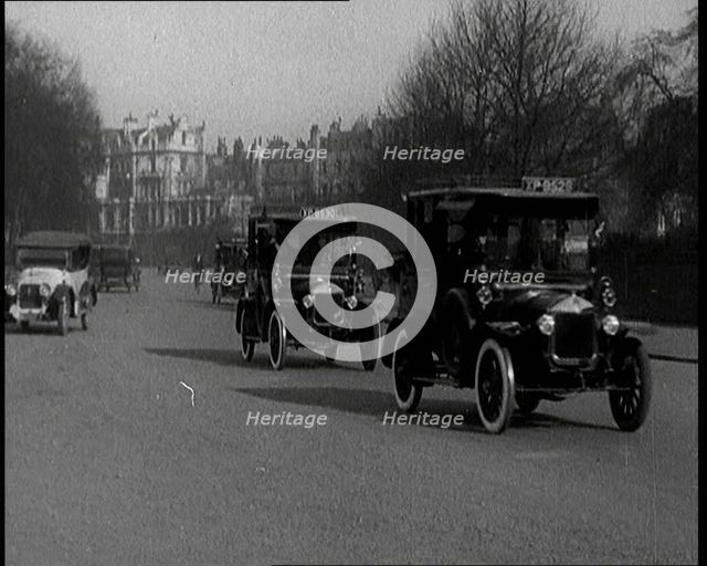 Taxis Drive Down a London Street, 1924. Creator: British Pathe Ltd.
