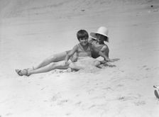 Taylor, Fenton, Mrs., and child, at the beach, 1931 Creator: Arnold Genthe