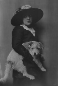 Taylor, Laurette, Miss, with dog, portrait photograph, 1913. Creator: Arnold Genthe