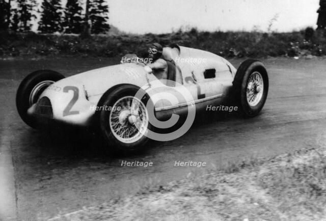 Tazio Nuvolari driving a 3 litre Auto Union in a Grand Prix, 1939. Artist: Unknown