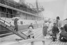 Taking Luggage off "Solace", 1914. Creator: Bain News Service