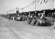 Talbot 105 and Lea-Francis cars in the pits at the JCC Double Twelve race, Brooklands, 8/9 May 1931. Artist: Bill Brunell