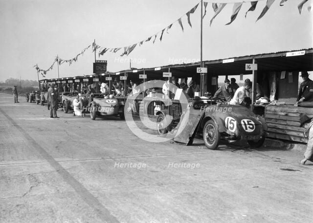 Talbot 105 and Lea-Francis cars in the pits at the JCC Double Twelve race, Brooklands, 8/9 May 1931. Artist: Bill Brunell.