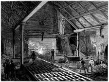 Tapping a blast furnace and running molten iron into the pigs c1885. Creator: Unknown