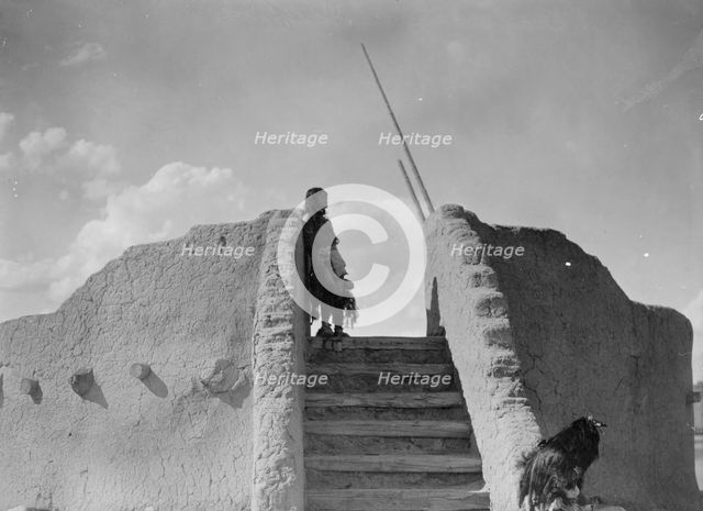 Tewa Indian guard at top of the kiva stairs, San Ildefonso, New Mexico, c1905. Creator: Edward Sheriff Curtis.