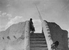 Tewa Indian guard at top of the kiva stairs, San Ildefonso, New Mexico, c1905. Creator: Edward Sheriff Curtis