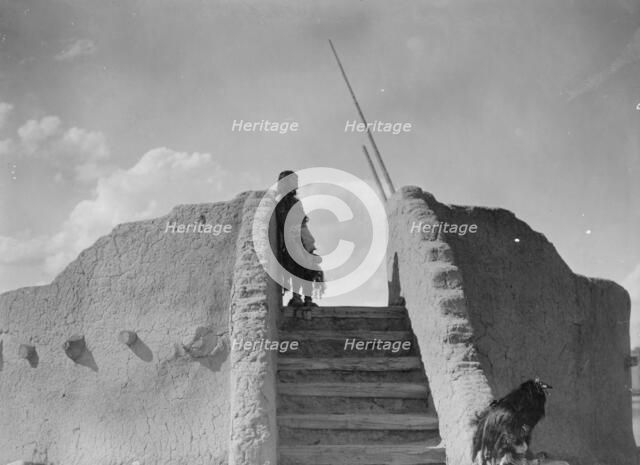 Tewa Indian guard at top of the kiva stairs, San Ildefonso, New Mexico, c1905. Creator: Edward Sheriff Curtis.