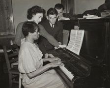 Teacher and student at piano, Jewish Settlement, 1938. Creator: Unknown