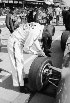 Technician checking tyre wear, Indianapolis, Indiana, USA, 1965
