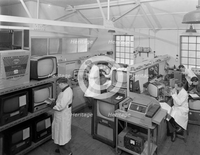 Technicians at work in Clays TV repair in shop, Mexborough, South Yorkshire, February 1959. Creator: Michael Walters.