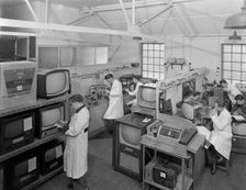 Technicians at work in Clays TV repair in shop, Mexborough, South Yorkshire, February 1959. Creator: Michael Walters