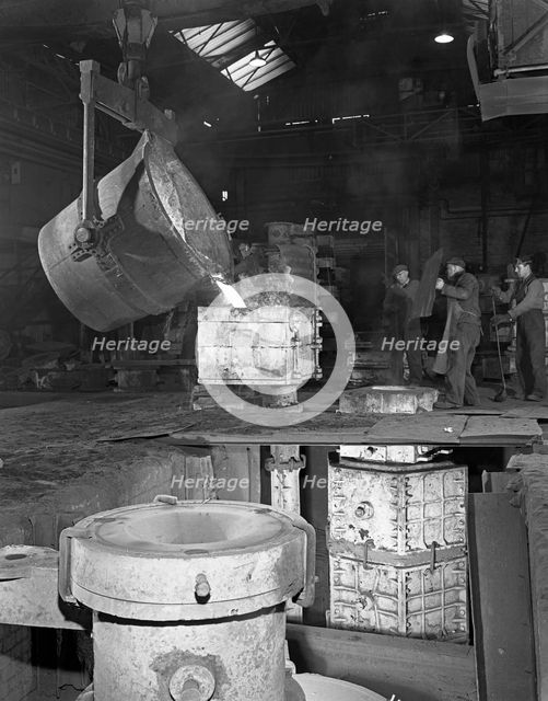 Teeming iron at Wombwell foundry, South Yorkshire, 1963. Creator: Michael Walters.