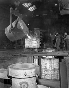 Teeming iron at Wombwell foundry, South Yorkshire, 1963. Creator: Michael Walters