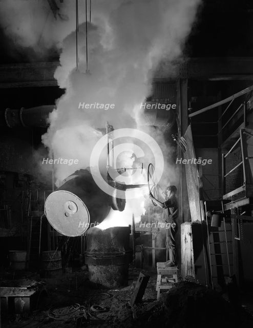 Teeming (pouring) molten iron at Edgar Allen's steel foundry, Sheffield, South Yorkshire, 1964. Creator: Michael Walters.