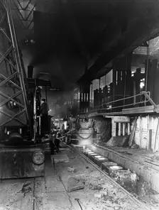 Teeming (pouring) molten steel, Park Gate Iron & Steel Co, Rotherham, South Yorkshire, April 1955. Creator: Michael Walters