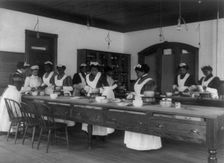 Ten Afro-American women in cooking class at Hampton Institute, Hampton, Va., between 1899 and 1900. Creator: Frances Benjamin Johnston