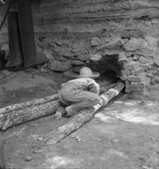 Ten year old son of tobacco tenant tends the fire..., Granville County, North Carolina, 1939. Creator: Dorothea Lange