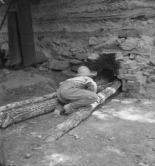 Ten year old son of tobacco tenant tends the fire..., Granville County, North Carolina, 1939. Creator: Dorothea Lange