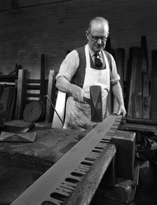 Tensioning the crosscut on a two metre saw blade, Sheffield, South Yorkshire, 1963. Creator: Michael Walters