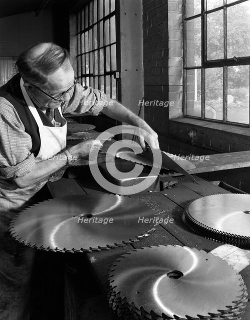 Tensioning circular saws at Slack Sellers & Co Ltd, Sheffield, 1963.  Creator: Michael Walters.